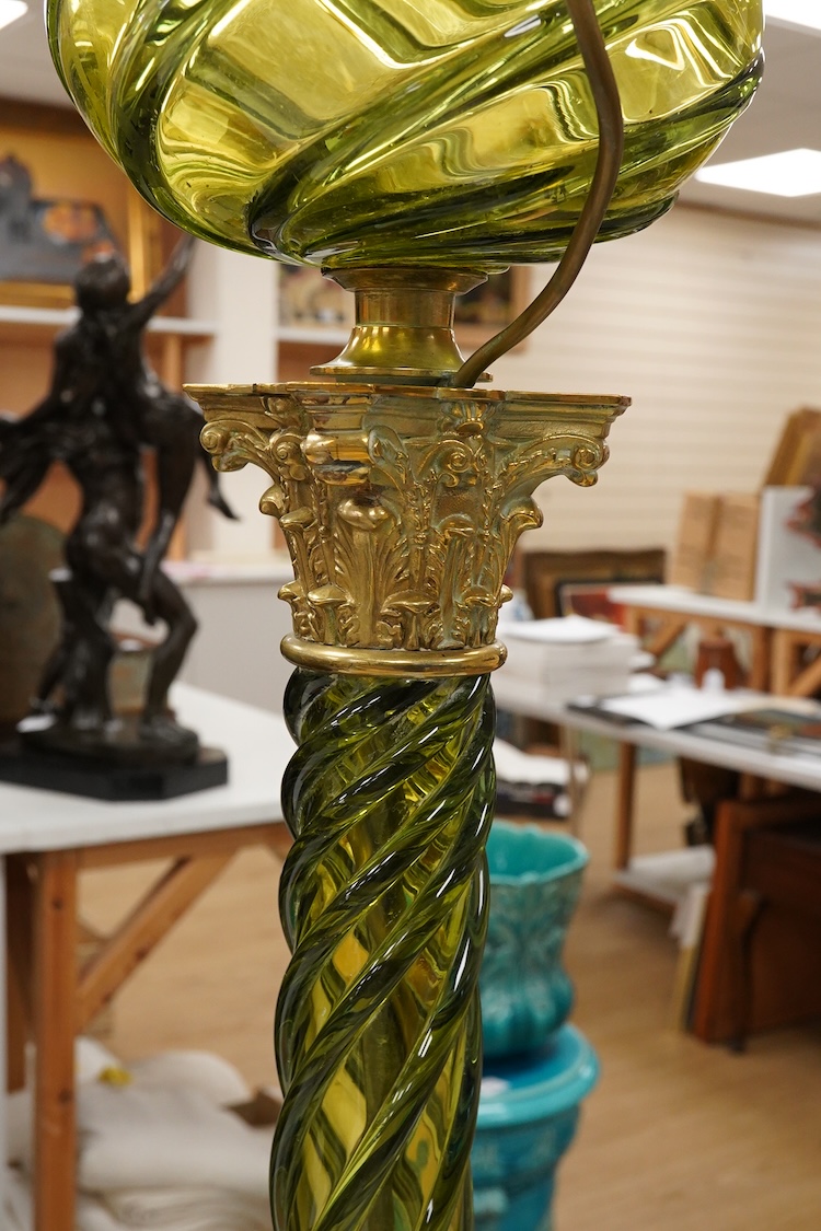A 19th century gilt and brass green glass corinthian columned oil lamp by Messenger, 68cm high